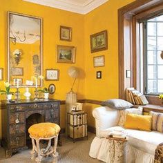 a living room filled with furniture and yellow walls