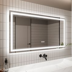 a bathroom with a sink, mirror and lights on the wall above it's counter