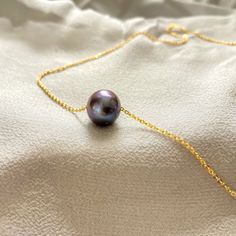 Pearls are gifts from the ocean. In Hawaiian, we call them "momi." A timeless symbol of serenity and wisdom. This stunning high-luster freshwater pearl floats on a gold vermeil or sterling silver adjustable necklace. A timeless piece to accessorize your style. Length: 16-18" adjustable Materials: 10-12mm Freshwater pearl. Gold vermeil or sterling silver chain. Collection: Hawaiian Ocean Collection Every pearl is unique. Color hues and pearl shape will vary (circular to slightly oval) All designs Hawaiian Ocean, Floating Pearl Necklace, Ocean Collection, Island Jewelry, Gold Pearl Necklace, Freshwater Pearl Necklace, Silver Moon, Pearl Pendant Necklace, Freshwater Pearl Necklaces