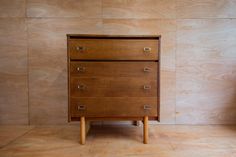 a wooden dresser sitting on top of a hard wood floor