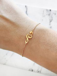 "14K 9K Gold Music Note Bracelet, Treble Clef Charm Bracelet, Dainty Music Note Bracelet, Solid Gold Bracelet, Musician Gift, Music Lover Gift, Christmas Gift, FREE EXPRESS SHIPPING Beautiful and delicate bracelet with a treble clef/note charm made in 14K or 9K solid gold. \"Music gives a soul to the universe, wings to the mind, flight to the imagination and life to everything.\" -- Plato Whisper...I love Music! -------------------------------------------------- D E T A I L S 14K Solid Gold or 9 Music-themed Bracelet Jewelry Gift, Music-themed Band Jewelry As Gift, Music-themed Band Jewelry Gift, Music Note Bracelet, Music Obsession, Music Bracelet, Music Symbol, Dream Rings, Lovers Bracelet