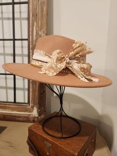 Custom Boho inspired Bolero/ Rancher style wide brim  Fedora Camel felt hat with Camel & ivory printed ribbon, ivory chiffon, ivory crochet trim, brown leather trim, gold chain and dried flowers. OS fits most, adjustable hat band. Hat has removable bands. These hats come in one size, they have an adjuster inside the crown to cinch them smaller.  We will include two foam reducing tape hat sizers to assist for a proper fit. Exact fit is not guaranteed or implied.  PLEASE make sure you are certain of your purchase before ordering. Because of various sanitary concerns, hats are NOT returnable or exchangeable. Ribbon Crochet, Hat With Ribbon, Crochet Ribbon, Western Purses, Rancher Hat, Bling Earrings, Boho Boutique, Wide Brim Fedora, Fancy Hats