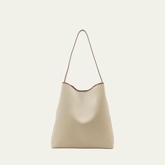 Aesther Ekme "Sac" hobo bag in cotton and faux leather (polyurethane) Shoulder strap  Open top with magnetic closure  Approx. 14.6"H x 14.2"W x 4.3"D Made in Spain Modern Beige Hobo Bag With Detachable Strap, Modern Hobo Bag With Detachable Strap For Shopping, Modern Beige Satchel With Magnetic Closure, Everyday Bucket Bag With Magnetic Closure, Everyday Beige Hobo Bag With Leather Handles, Beige Leather Hobo Bag For Errands, Modern Beige Bag With Magnetic Closure, Cream Hobo Bag With Soft Leather And Double Handle, Modern Everyday Bucket Bag With Magnetic Closure