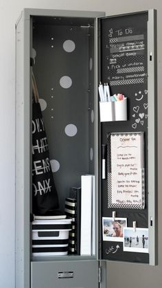 an open locker with writing on the door and chalkboard in it's center