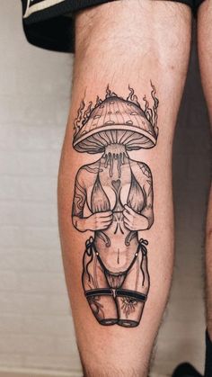 a man's leg with a tattoo on it that has an image of a woman holding a mushroom over her head