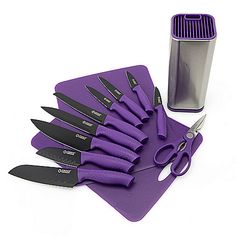 a set of purple knives sitting on top of a cutting board