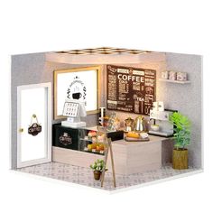 a miniature model of a coffee shop with items on the counter and in front of it