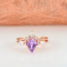 Beautiful Vintage Inspired Kite Cut Amethyst Ring Set ►Base Metal: Sterling Silver (925) ►Plating: 14K Rose Gold ►Accented With Simulated Diamonds (CZ) ►Please be aware that plated jewelry can wear off over time, if this is a concern we would suggest going with the sterling silver or solid gold option. Center Stone: Amethyst Shape: Kite Gem size: 7.0 x 10.0 mm Carat Weight: 1.4 ct. (approx.) Gemstone creation: Natural Hardness: 7 (Mohs scale) ✓ Comfort Fit ✓ Free Ring Box ✓ Free USA Shipping ✓ R Rose Gold Amethyst Promise Ring, Rose Gold Amethyst Gemstone Ring For Promise, Promise Amethyst Ring In Rose Gold, Rose Gold Amethyst Ring With Gemstone Accents For Wedding, Promise Rose Gold Amethyst Gemstone Ring, Rose Gold Amethyst Crystal Ring With Gemstone, Amethyst Ring Engagement, Future Engagement Rings, Bridal Ring Sets