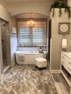 a bath room with a tub a sink and a window