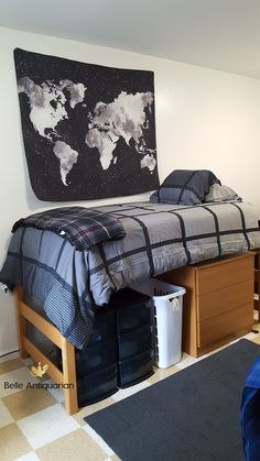 a bed sitting in the middle of a bedroom next to a wall with a map on it