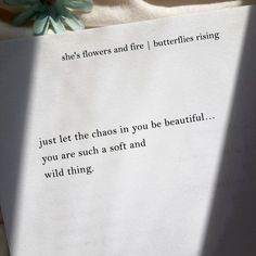 a piece of paper with a poem written on it next to a flower and a pen