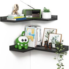 there are two shelves with books and toys on them, one shelf has a green monster