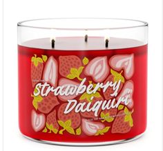 a red candle with strawberries on it and the words strawberry daiquit written in white