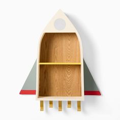 a wooden shelf with a rocket ship design on the top and bottom, along with two shelves