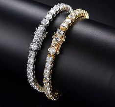 "Our best-selling diamond tennis chain bracelet is a classic and stylish design. This is a must-have for many that goes well in any occasion. Each round diamond created for optimum aesthetics. Our cubic Zirconia diamonds are measured at approximately 5mm each, all individually harbored and secured by hand for maximum quality, shine, and brilliance. Diamond Specifications Type: VVS Simulated Diamond | Cubic Zirconia Shape: Round Size: 5mm Necklace Specifications: 14k White Gold PVD Plated (Highes Mens Chain Bracelet, Cubic Zirconia Bracelet, Tennis Chain, Chain Bracelets, Diamond Chain, Hip Hop Jewelry, Tennis Bracelet Diamond, Timeless Jewelry, Mua Sắm