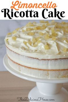 a cake with white frosting and pineapples on top is sitting on a plate