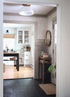 an open door leading to a kitchen and dining room