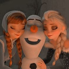 two girls are hugging a snowman in front of the camera with their eyes closed