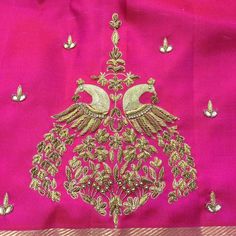 the back of a pink silk saree with gold embroidery work on it and two peacocks