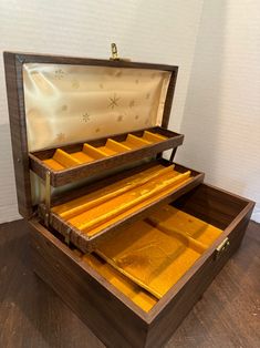 an open wooden box with gold bars in it