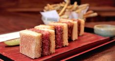 small sandwiches are arranged on a red plate