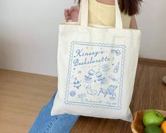 a woman sitting on the floor with a bag in front of her and some fruit