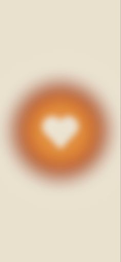 an orange circle with a white heart in the center on a beige background that appears to be blurry