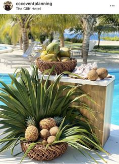 pineapples, bananas and other fruit in baskets by the pool