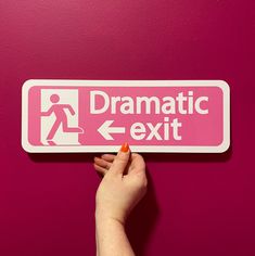 a hand is pointing to a pink sign with the words dramatic exit and an arrow