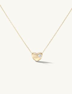 Details Semi-Solid 14k gold heart bauble inlaid with a round lab grown diamond. The bauble slides on a solid 14k gold sparkling diamond cut chain. Personalize this piece with a custom engraving of a special date or initials, up to five characters. This Valentine's Day, we're celebrating ourselves with a capsule collection of pendants featuring bauble designs with continual soft contoured shapes inspired by the elegance of the human form. Measurements Bauble: 10mm length, 6mm width, 8mm height Ca Bauble Designs, Pebble Pendant, Heart Disc, Nyc Studio, Human Form, Sparkling Diamond, Heart Pendant Diamond, Capsule Collection, Contemporary Jewelry