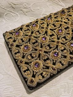 "Absolutely exquisite elegant evening bag. Embroidered best-quality black velvet. The geometric pattern is hand embroidered with gold metallic thread.  Amethyst and garnet genuine semi-stones add this special rich jewelry look.  Snap closure. Very elegant back strap. Size: 8\" x 5\" Perfect condition. Excellent gift. FREE SHIPPING Thank you for visiting my store. You can also visit my AmazingClosetShop or http://jewelryandclothing.net/ Please read \"The Private Policy\"" Embroidered Rectangular Formal Clutch, Formal Embroidered Rectangular Clutch, Formal Rectangular Embroidered Clutch, Embroidered Clutch Evening Bag For Formal Events, Hand Embellished Black Evening Bag, Luxury Hand Embellished Black Evening Bag, Luxury Hand-embellished Black Evening Bag, Luxury Black Hand Embellished Evening Bag, Black Hand Embellished Evening Bag