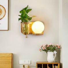 there is a vase with flowers on the shelf next to a lamp and bookshelf