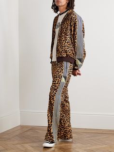 KAPITAL's leopard-print track pants are a bold take on a sportswear classic. Trimmed with striped webbing, they've been made in Japan from substantial tech-jersey and have straight, flared hems with side zips to adjust the fit. If you’re feeling confident, pair them with the matching jacket in our edit. Kapital Clothing, Leopard Outfits, Animal Print Pants, Luxury Sportswear, One Piece Clothing, Jersey Jacket, 2024 Style, Feeling Confident, Track Suit