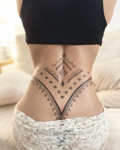 a woman's lower back tattoo with geometric designs on her body and bottom part