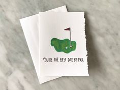 two cards with the words you're the best dad by day on them, and a green golf hole