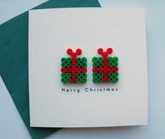 two green and red beads with the words merry christmas written on them in small letters