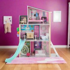 a doll house with furniture and accessories in a room painted bright purple, pink and white