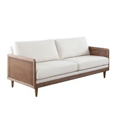 a white couch sitting on top of a wooden frame