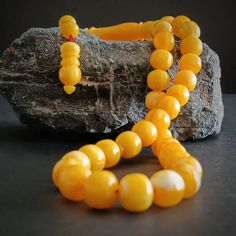 This yellow tasbih is handmade. All 33 beads of tasbeeh are made of yellow faturan amber. Tightening amber prayer beads is a synthetic resin made from "phenol and formaldehyde", some amber powder and various chemicals. Also, this product changes color as it is used and this feature makes it unique. These fire amber rosary are a nice muslim chapelet gift idea. Tassel material of this misbah is stainless metal.  PRODUCT DETAILS Weight: 48gr Grain Length: 11mm (0.44") Grain Width: 12mm (0.47") Tota Yellow Beaded Necklace With 8mm Beads As Gift, Traditional Yellow Beads For Gift, Traditional Yellow Necklace With 8mm Beads, Yellow Spiritual Rosary As Gift, Yellow Polished Beads For Gifts, Traditional Amber Rosary, Traditional Amber Rosary With Round Beads, Yellow Spiritual Hand-strung Beaded Bracelets, Cheap Traditional Yellow Beads