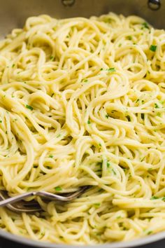 a bowl filled with pasta and topped with parsley