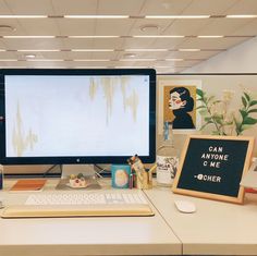 two computer monitors sitting on top of a desk next to each other in an office