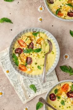 two white bowls filled with food on top of a table