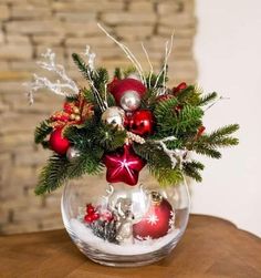 a vase filled with ornaments on top of a wooden table