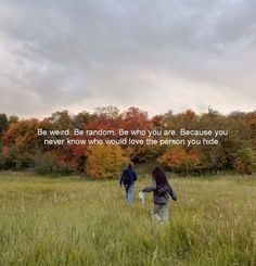 two people walking through a field with trees in the background and a quote written on it