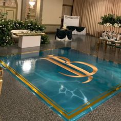 a large blue and gold dance floor in a ballroom