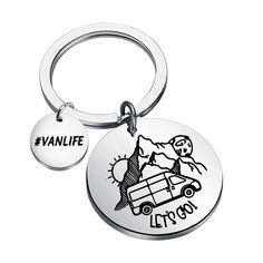 a round keychain with an image of a vanlife car and the words let's go