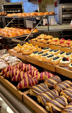 many different types of pastries on display in a bakery