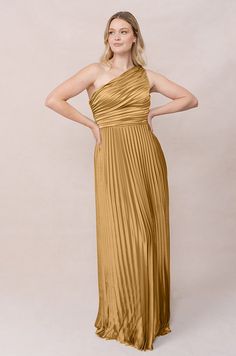 Model: Sydney; Size: 10; Color: Gold Pre-draped One Shoulder Dress For Prom, Pre-draped Bridesmaid Dress With Asymmetrical Neckline, One Shoulder Dress With Ruched Bodice For Gala, One Shoulder Ruched Maxi Dress For Gala, One-shoulder Ruched Maxi Dress For Gala, One Shoulder Dress With Ruched Fitted Bodice, Fitted One Shoulder Dress With Pleated Bodice For Gala, Gala One-shoulder Dress With Ruched Bodice, Asymmetrical Ruched One Shoulder Gala Dress