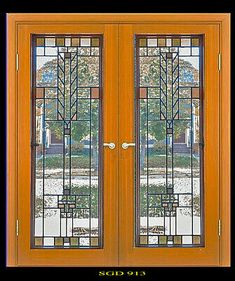 an orange double door with stained glass panels