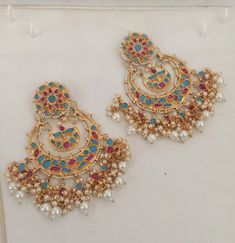 *It is Handmade Chandbali Indian Ethnic Kundan Earrings. *Its made from Silver n Copper with Multi color Kundan pink and turquoise Stones Settings with 22k gold Plating. *It gives Pure Ethnic Look with Antique Touch and is 3.5 inches Long. *Our all jewelry is made from semiprecious stones and beads. *WARRANTY: ITS GENUINE HANDMADE JEWELRY AND WE GIVE LONG LIFE WARRANTY FOR OUR ALL ITEMS. All of our Kundan Jewelry is 100% handmade with ancient Kundan stone setting method using silver foils. It is Multicolor Temple Jewelry Chandbalis With Tilla, Multicolor Chandbalis With Tilla In Temple Jewelry Style, Traditional Multicolor Chandbali Hoop Earrings, Multicolor Chandbali Chandelier Earrings, Multicolor Chandbali Earrings With Cutdana, Traditional Kundan Pearl Earrings With Cutdana, Multicolor Heavy Chandbali Bridal Earrings, Multicolor Traditional Hoop Earrings With Latkans, Multicolor Chandbalis With Cutdana For Diwali